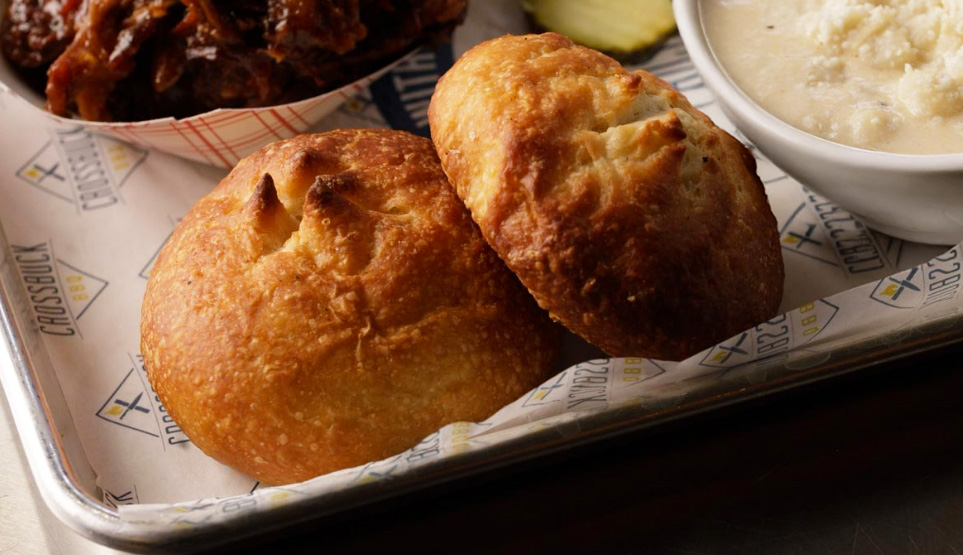 Crossbuck BBQ's fresh baked bread on a tray with pulled pork