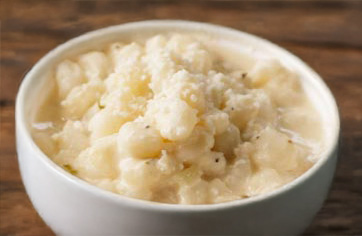 Crossbuck BBQ's Fresh Hominy with Epazote, Herbs, Heavy Cream and cotija cheese.